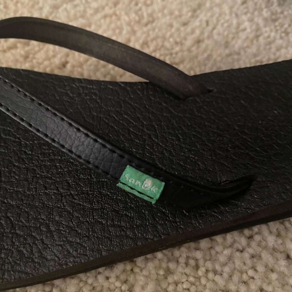 Black Sanuk flip flops
